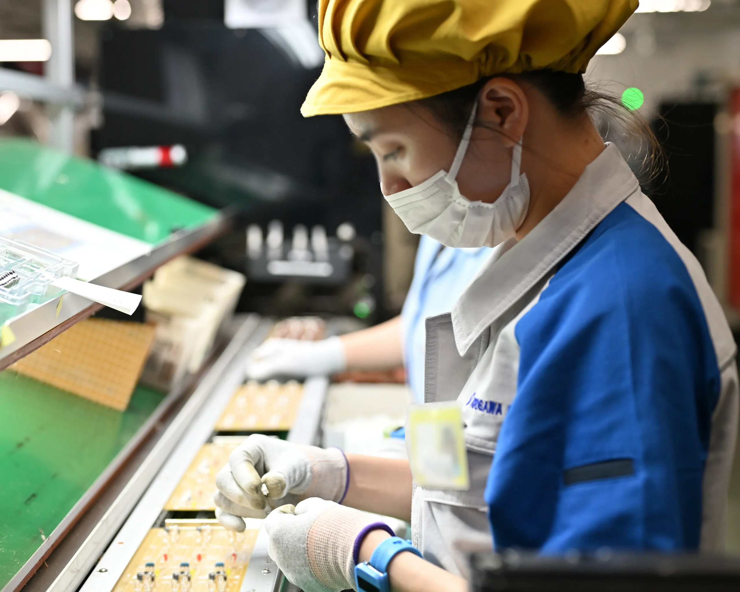 LEDを始めとする電子部品を手挿入する様子。淡々とした作業にあっても、目標設定と継続的な行動が仕事のやりがいを生み、組織全体の生産性と雰囲気を向上させる。