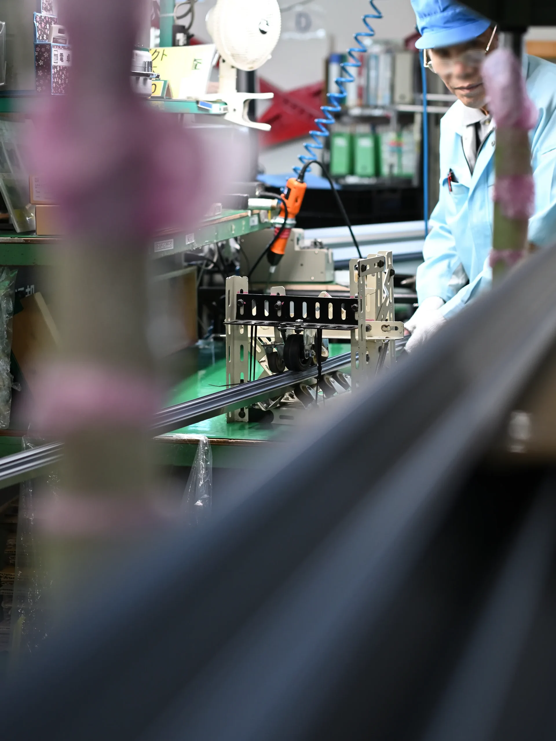 ダクト資材を、治具を使って組み立てる従業員