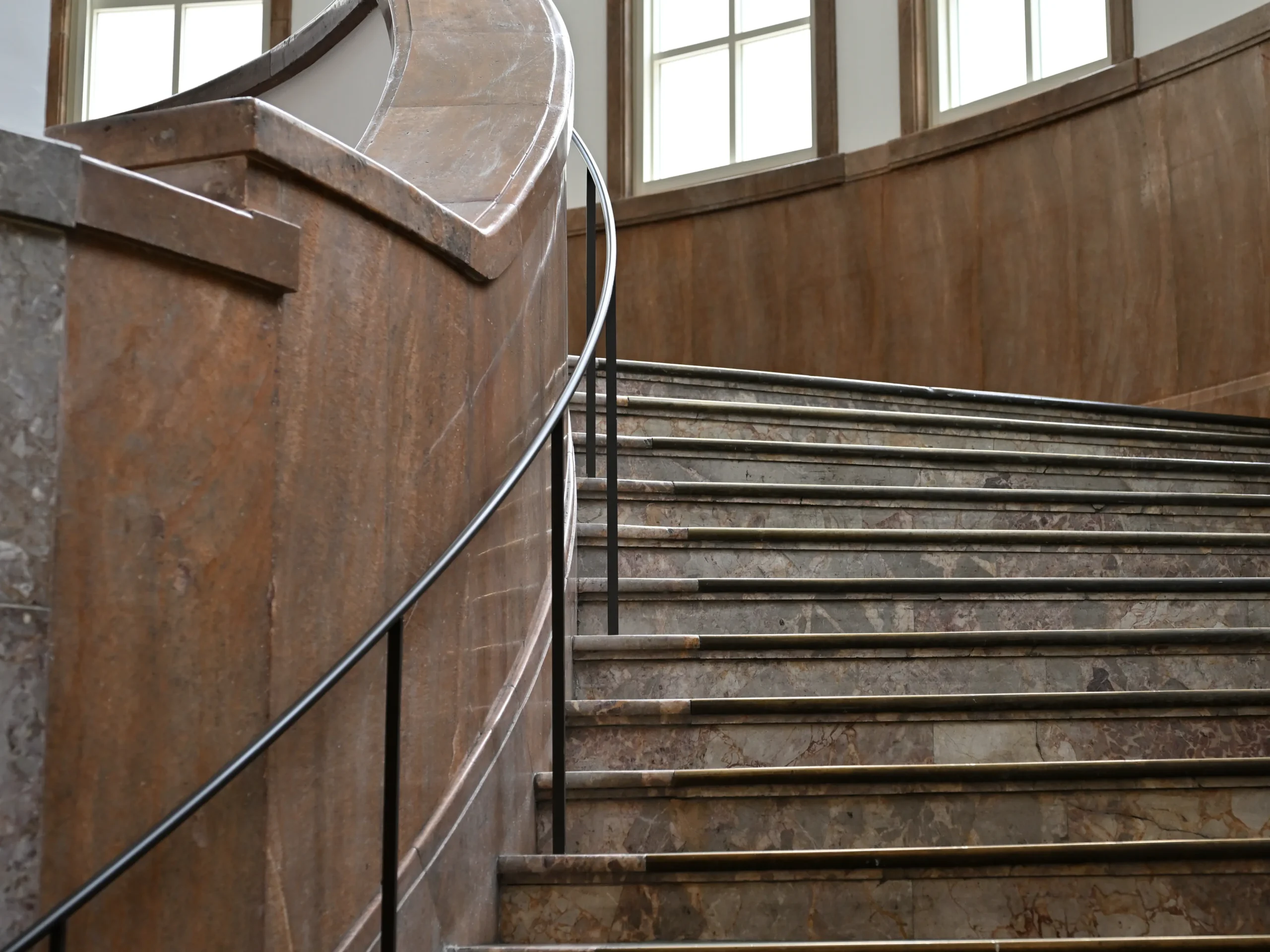 京都市京セラ美術館の館内にある曲線美が際立つ大理石の階段。自然光が差し込むモダンな建築空間が、西洋絵画展『どこ見る?どう見る?西洋絵画!』の鑑賞体験を引き立てる。